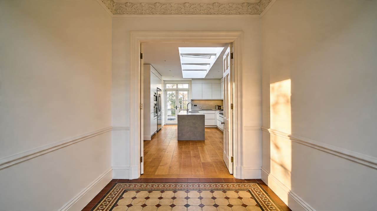 Full house renovation in progress in a London Victorian terrace by TB&D Construction — structural walls opened, new RSJ beams installed.